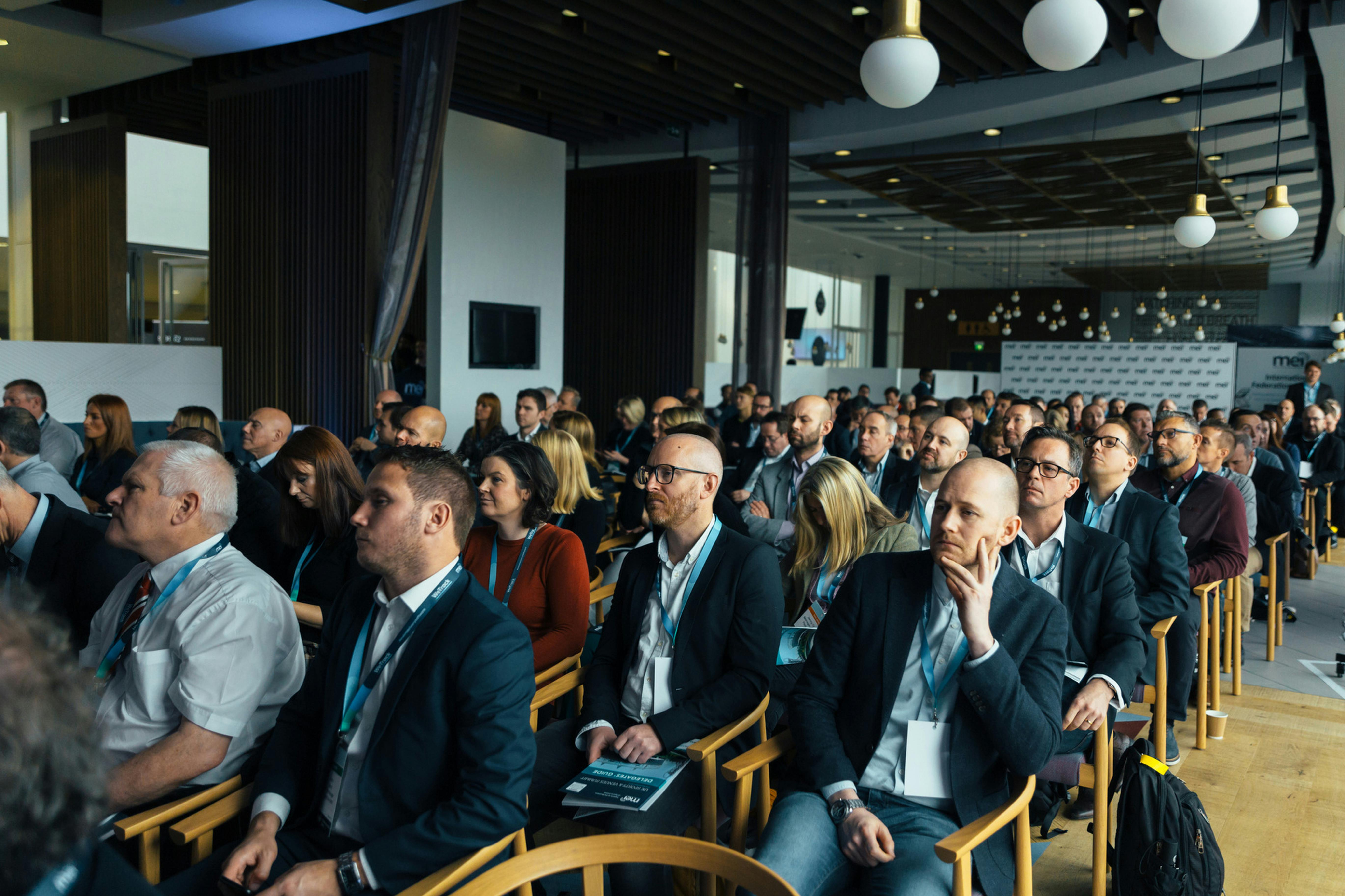 A mixed crowd sitting at an event